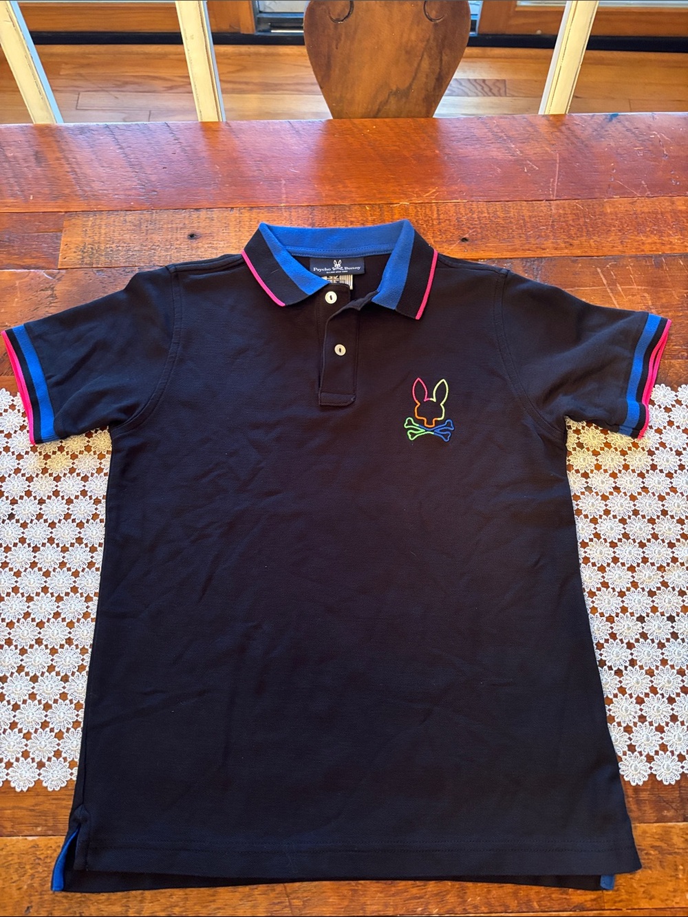 Boy’s Psycho Bunny Black Polo with Neon Trim and Rainbow Log. Size L